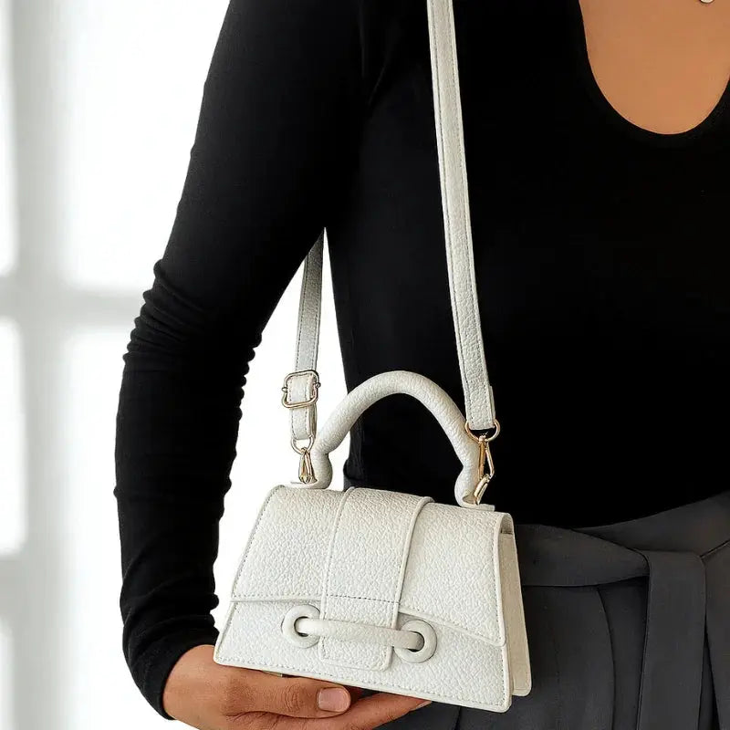 Mini sac bandoulière femme blanc porté à l’épaule.